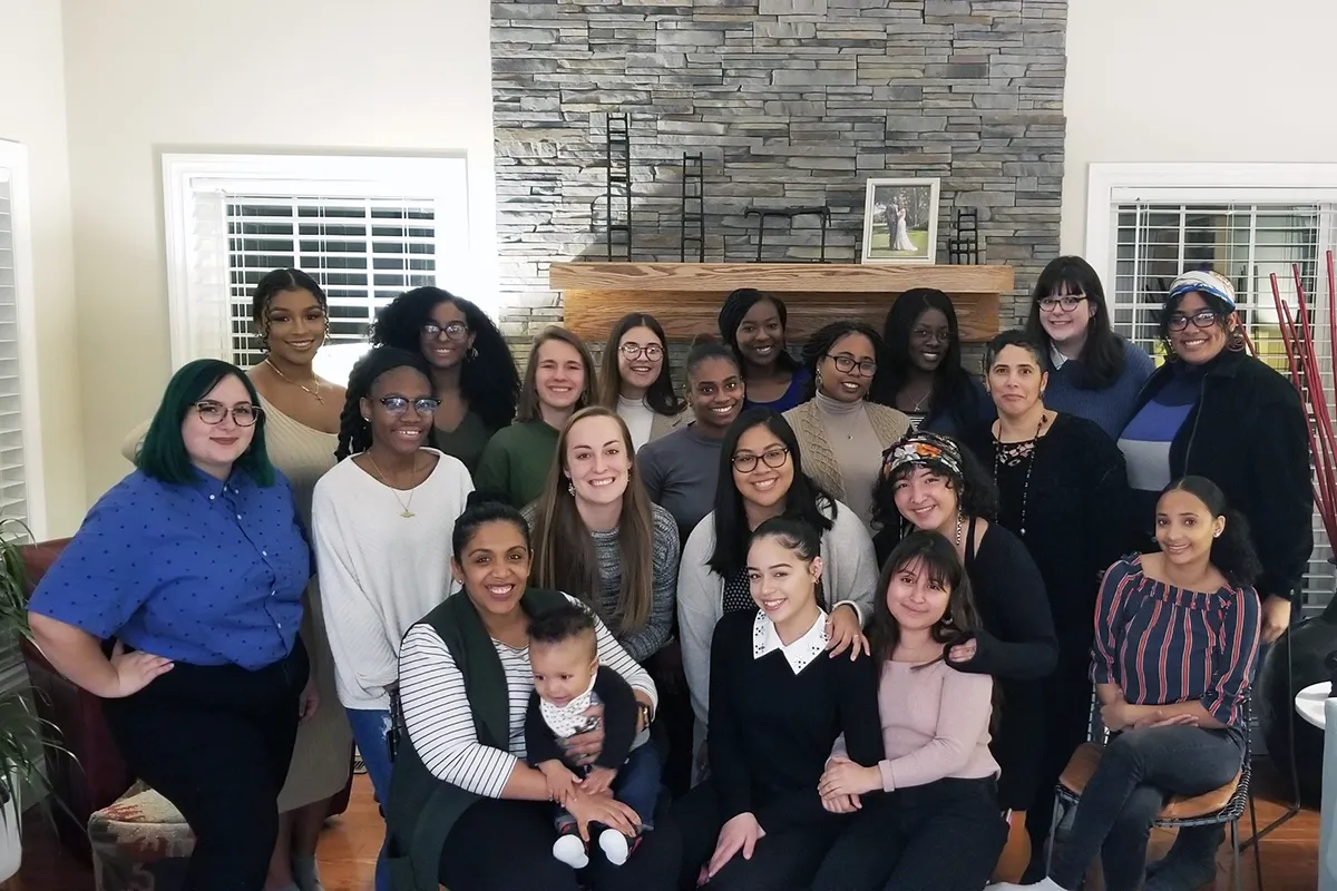 women in front of a fireplace