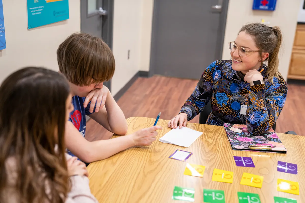speech pathology student works with children