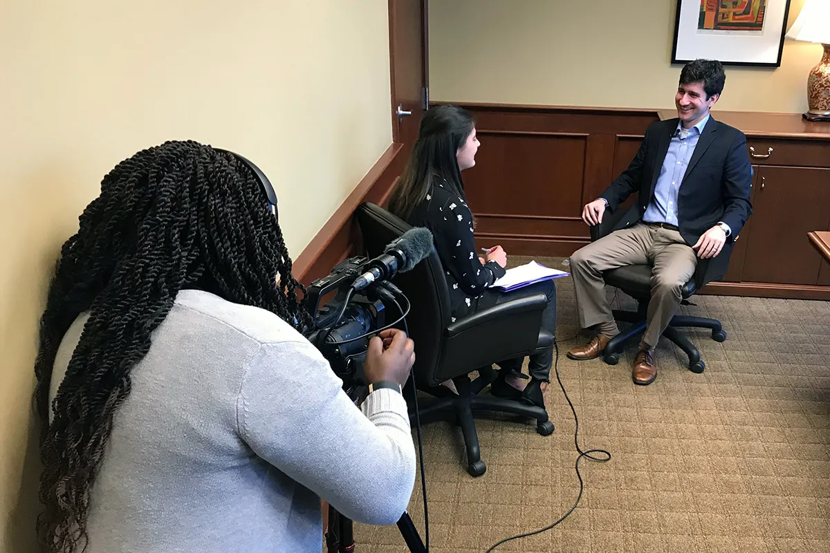 students interview man