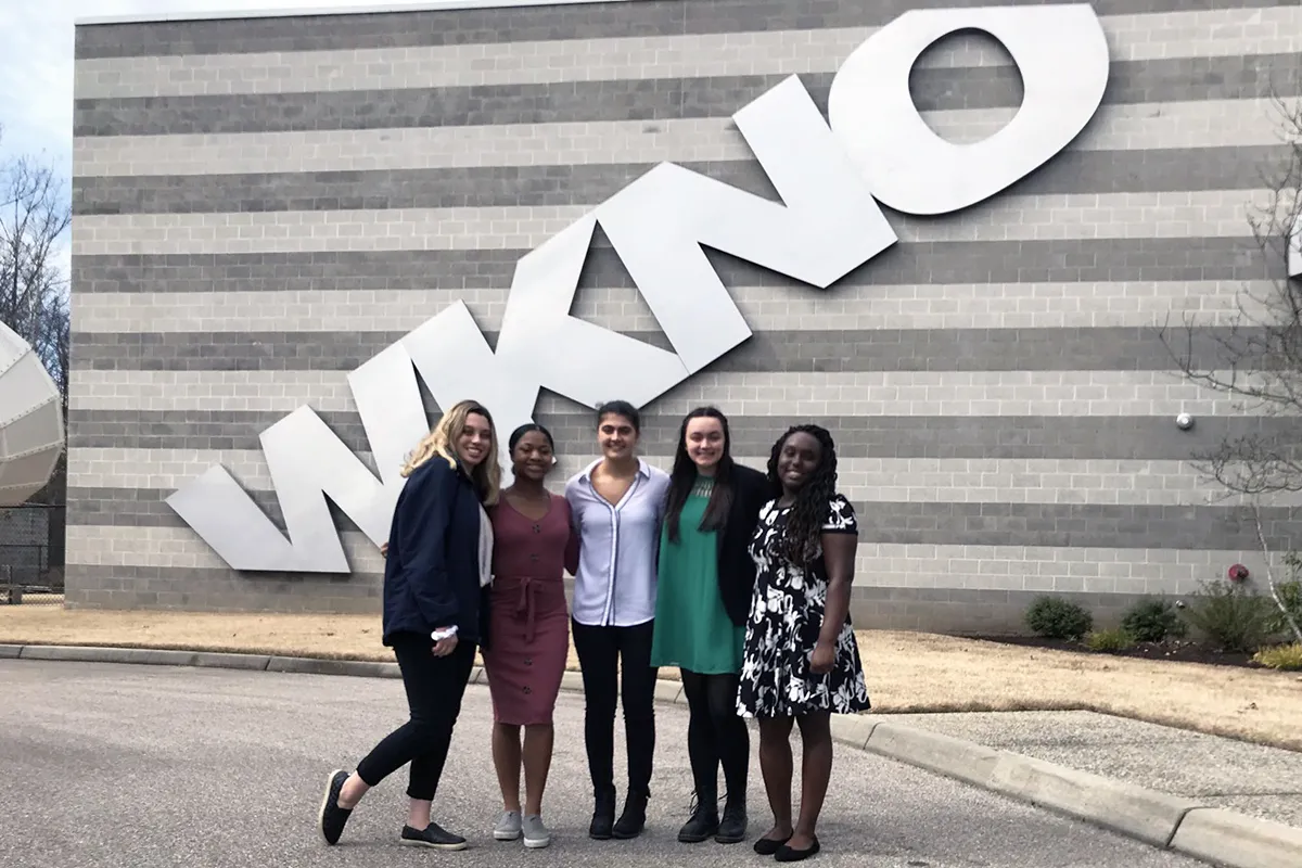 students outside television station