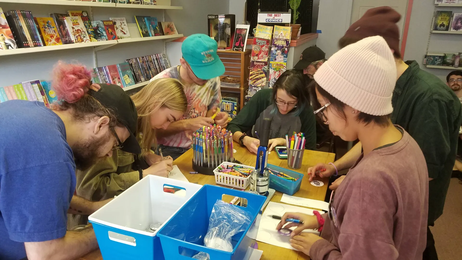 Students making pins at fundraiser at Comics for Collectors