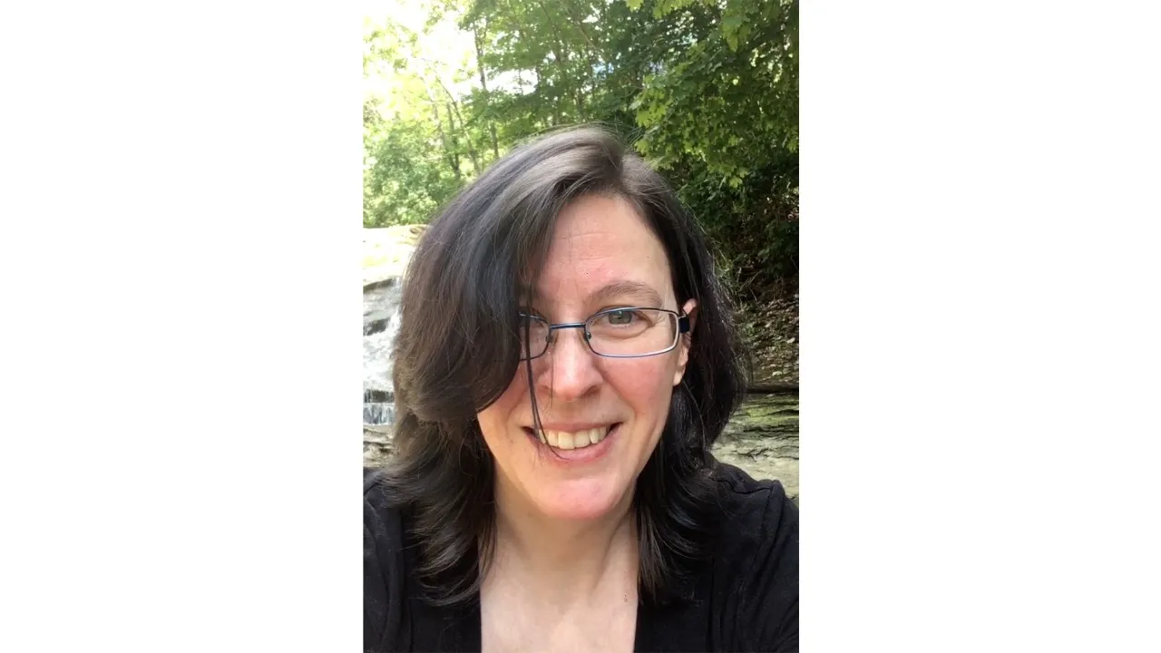 a woman smiles at the camera