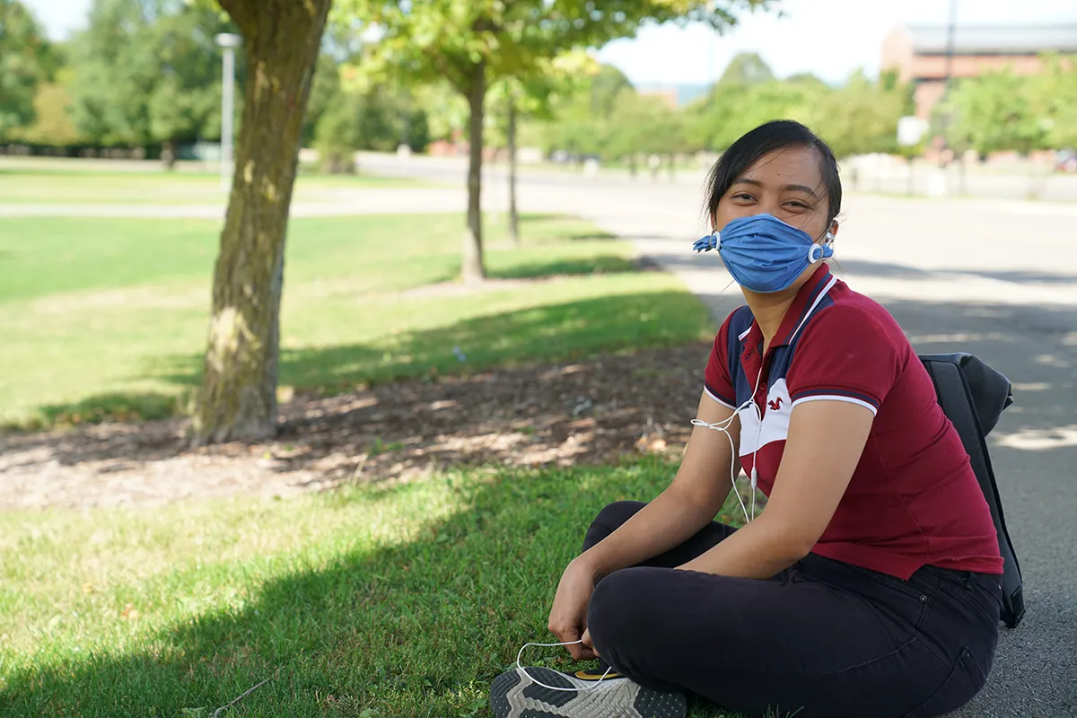 student wearing a mask on the quad
