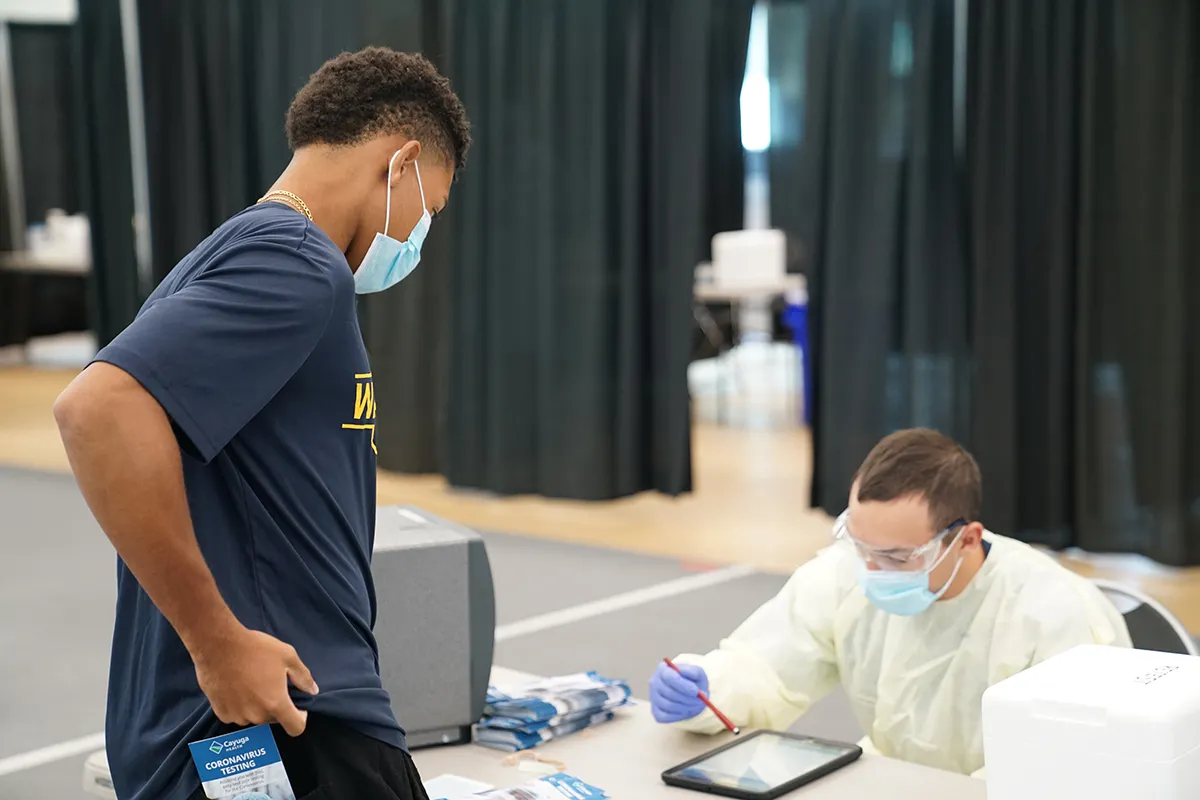 student signing in to get tested for COVID