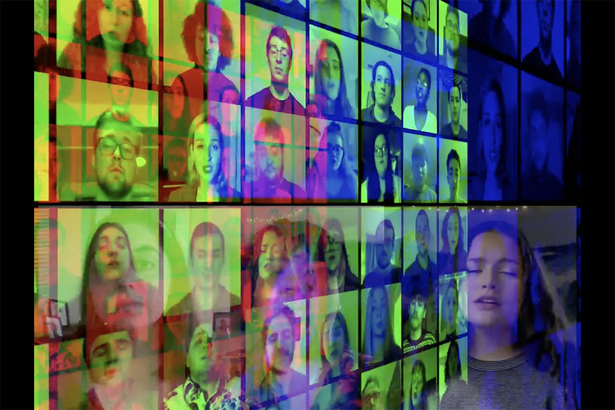 A screen showing singers in a virtual concert