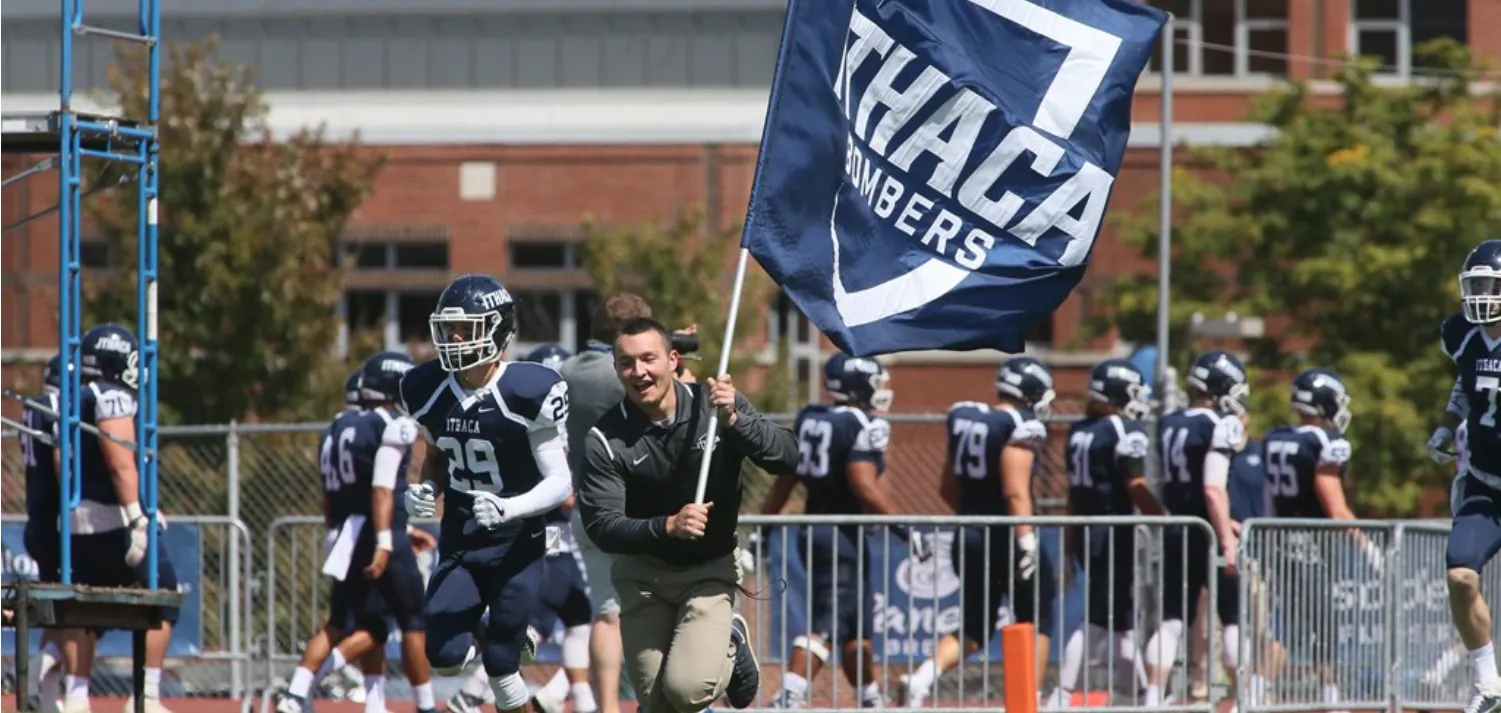 Student charging the field with football team