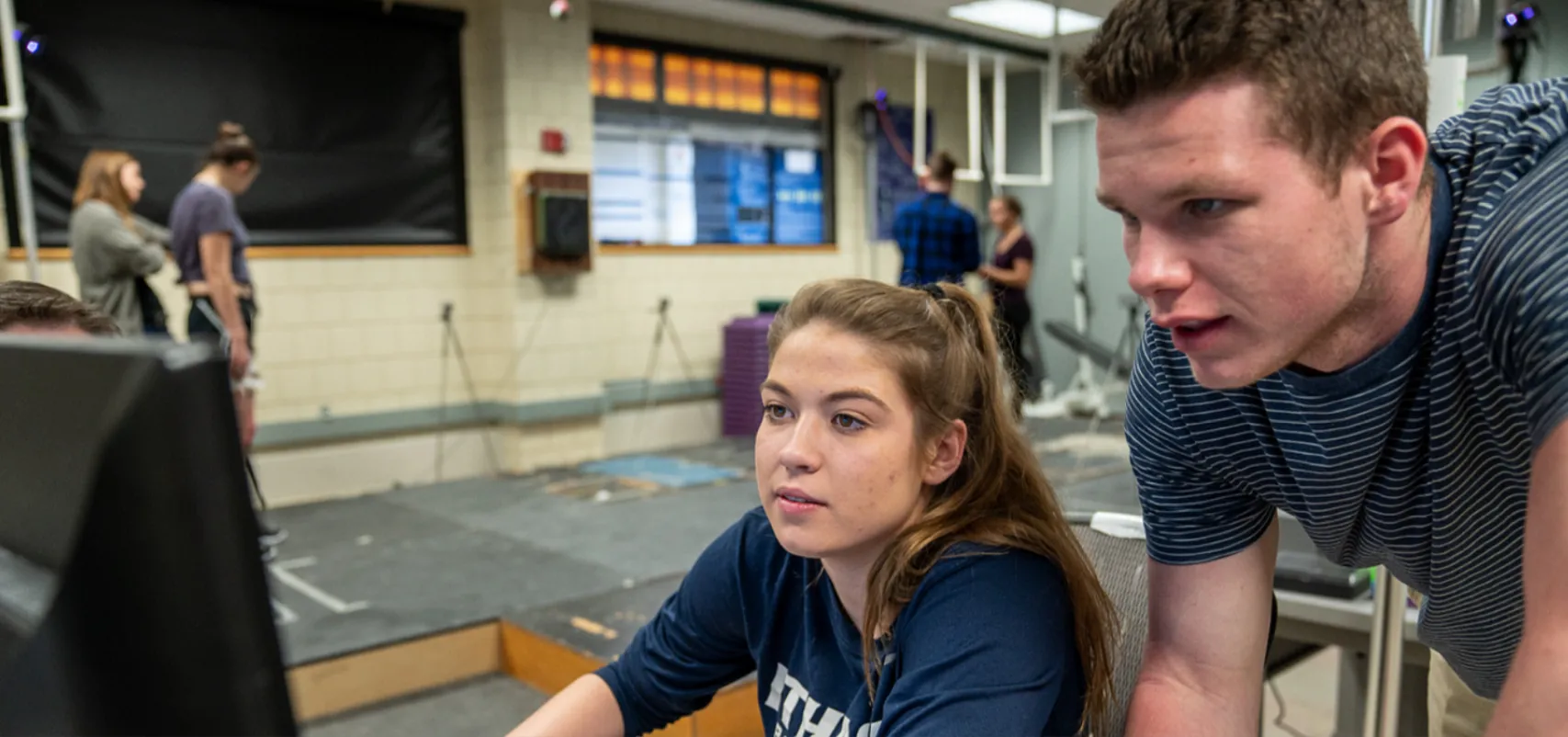 Students analyzing running mechanics on computer