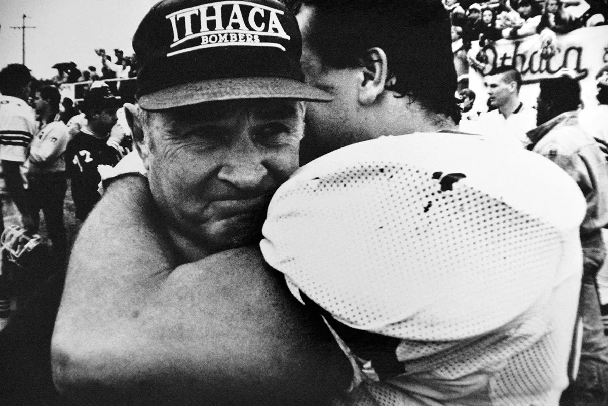 football player hugging coach