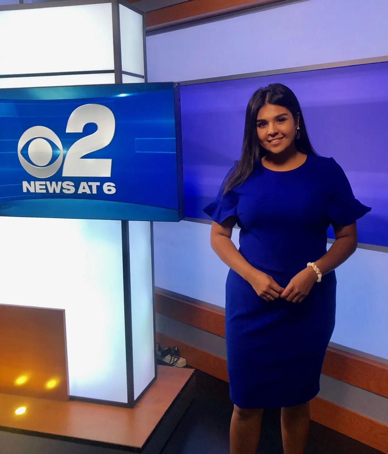 Journalist Emily Chavez standing in newsroom