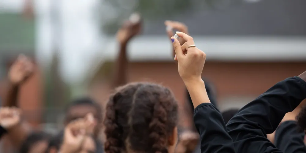 Student holding a pebble