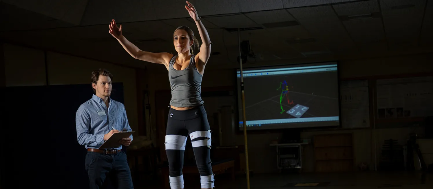 student measures biomechanics of client jumping off a box
