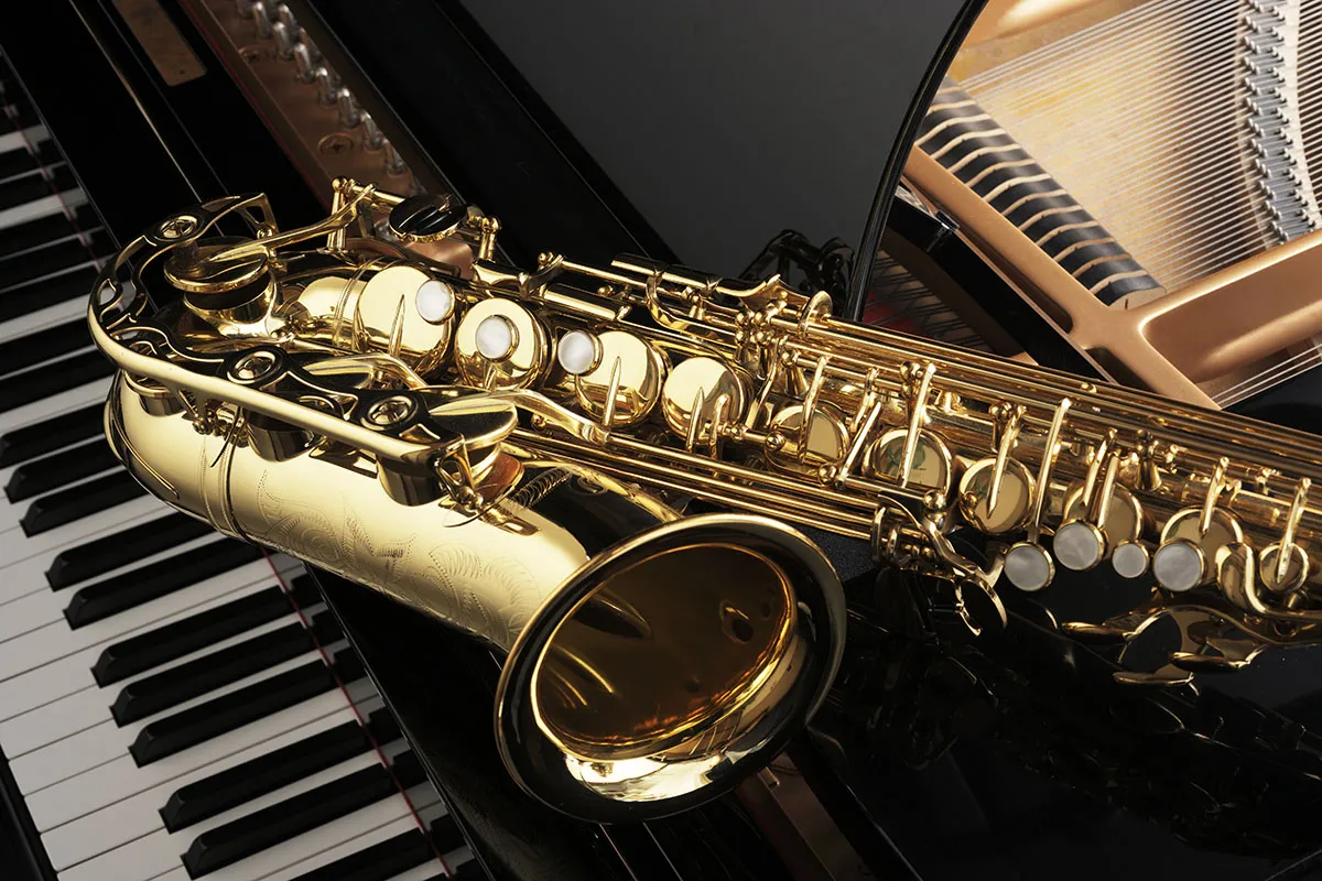 Saxophone on top of a piano