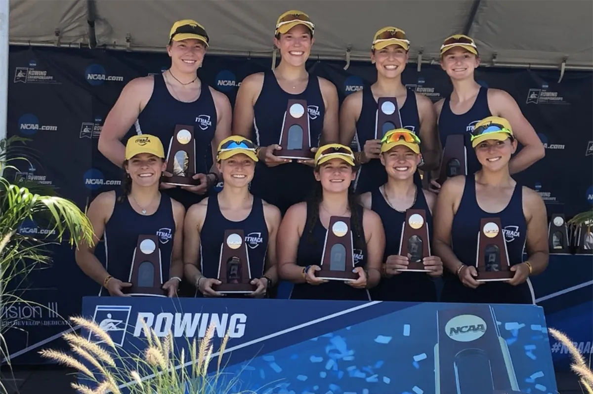 Women's crew team holding trophies