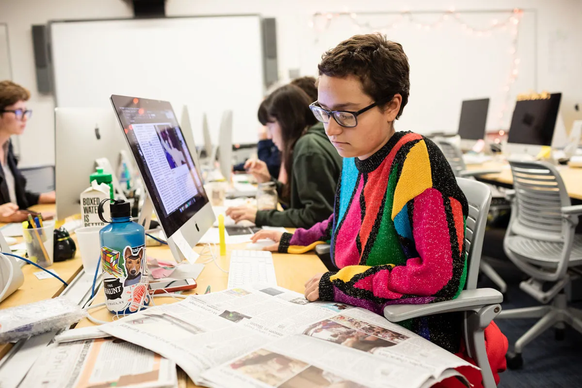 Student working at her desk at The Ithacan