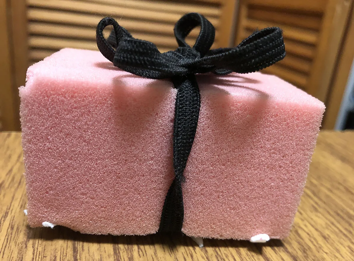 The pink squeezy grip in a black bow