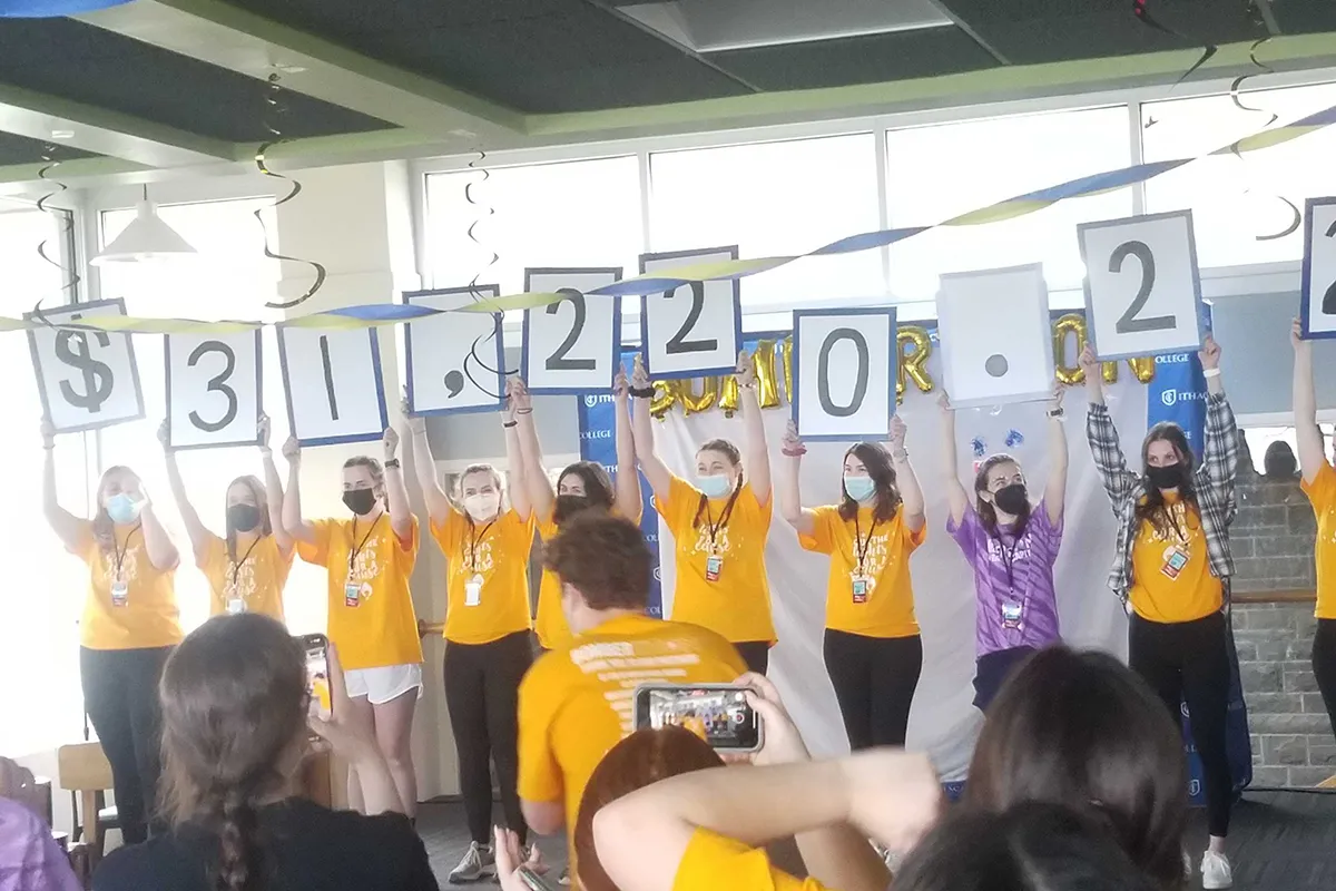 Students holding up signs