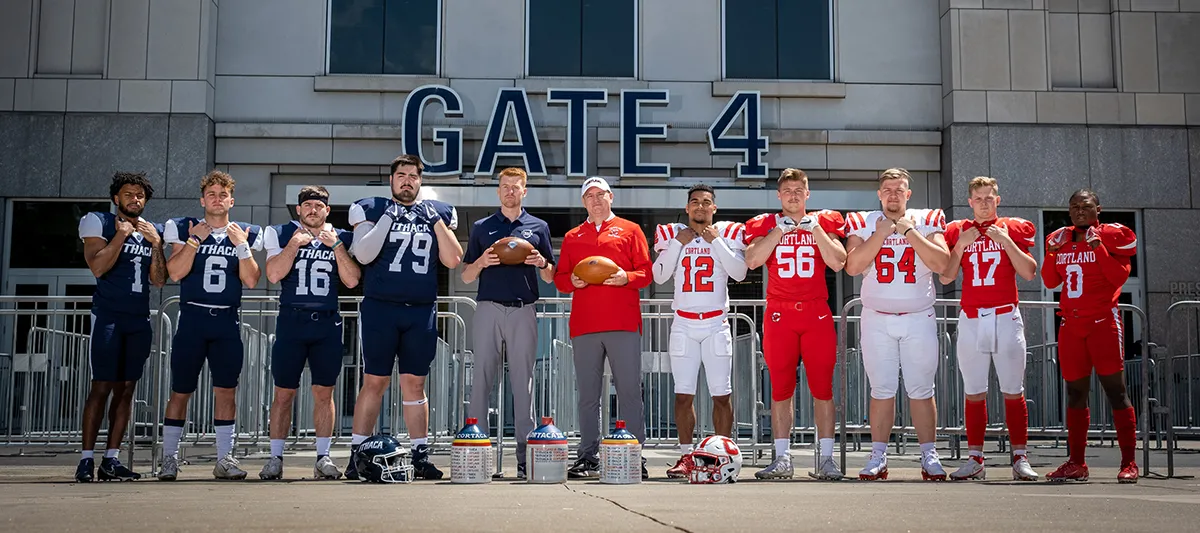 Ithaca and Cortland players and coaches standing outside Yankee Stadium