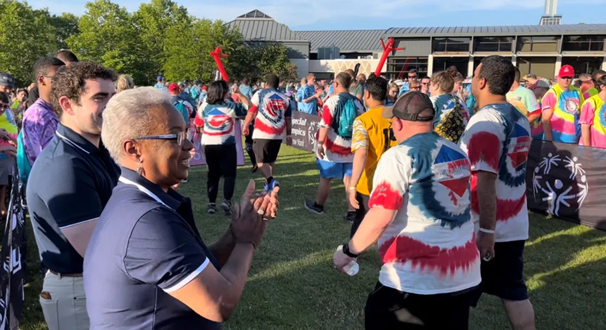Athletes walking into the quad, being cheered on