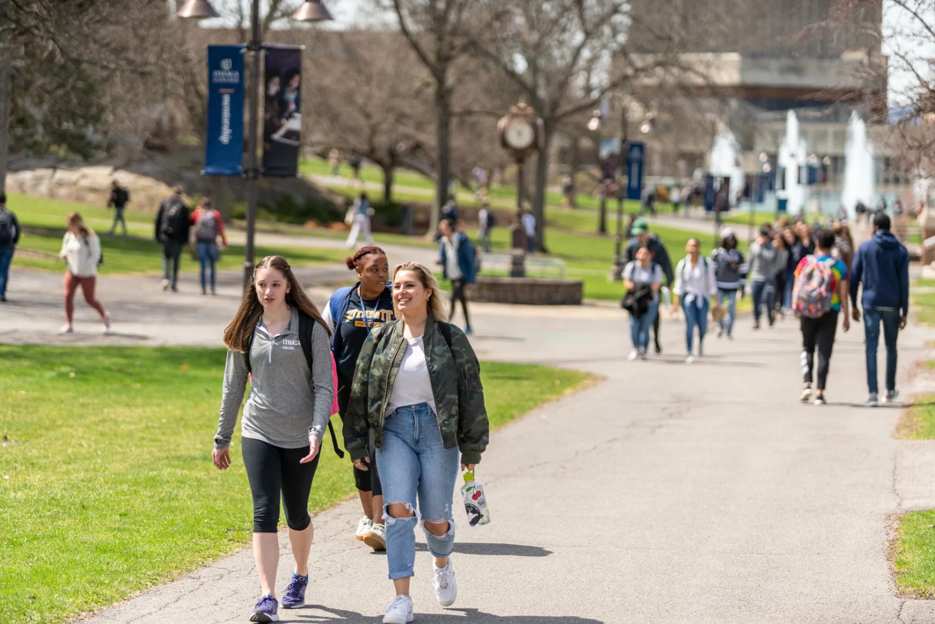 Ithaca College students walking in front of fountains