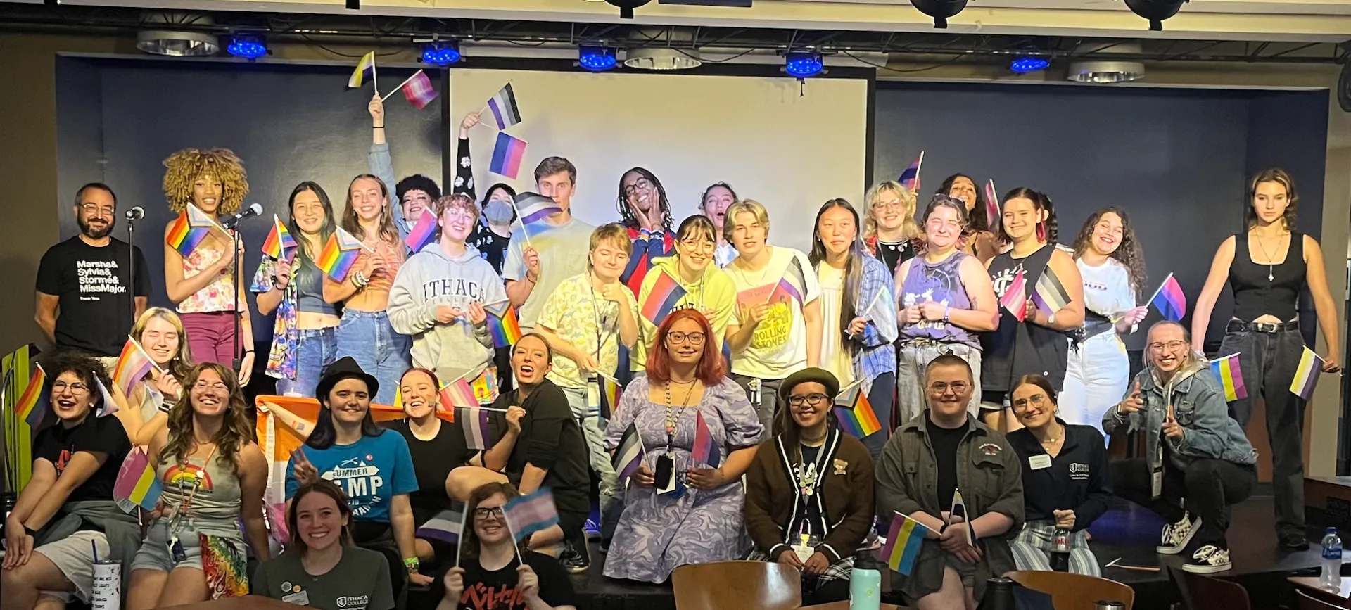 Students standing on stage at Pride night.