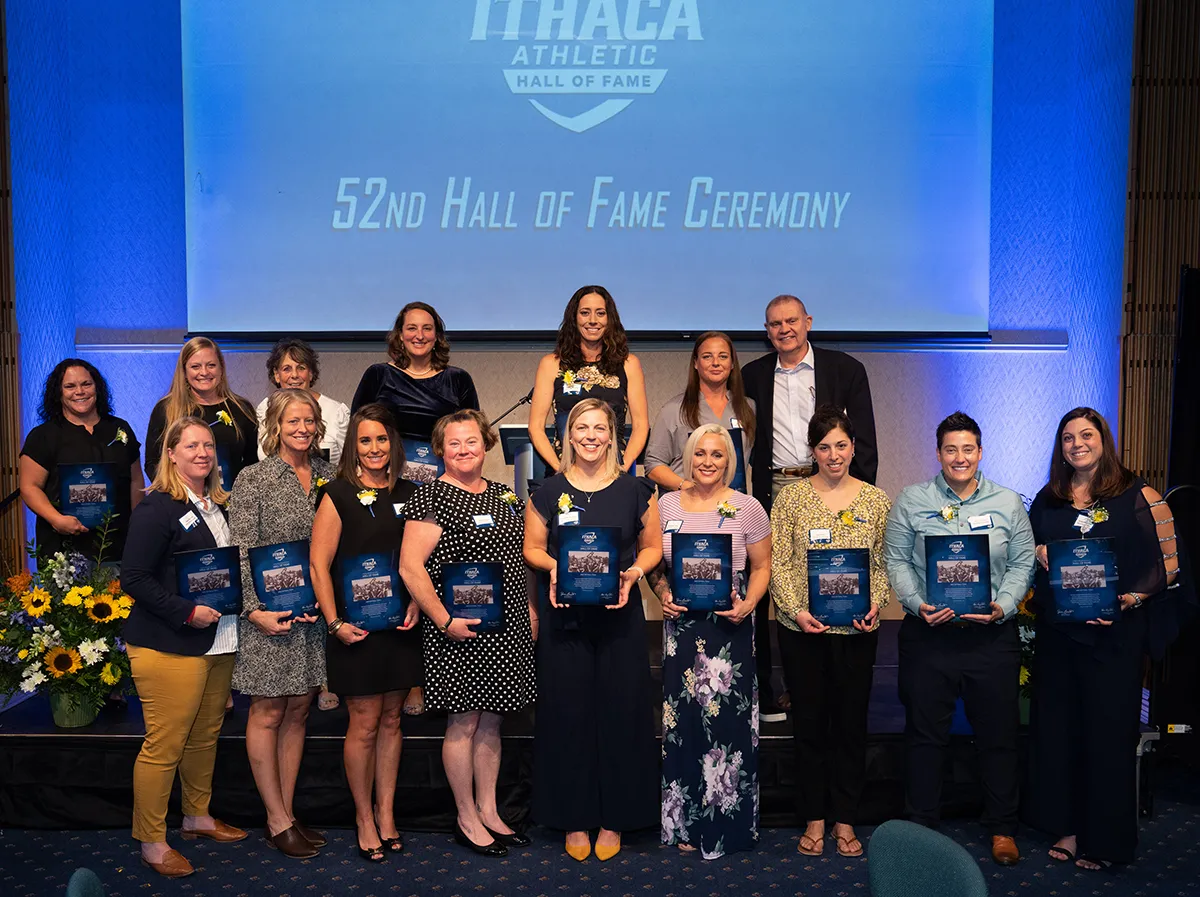 The 2002 Women's Softball Team holding awards