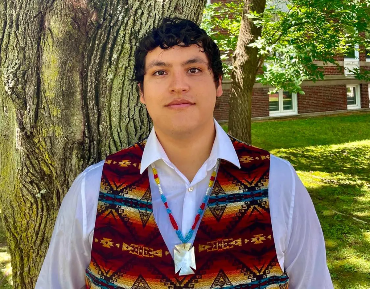 Victor A. Lopez-Carmen standing against a tree