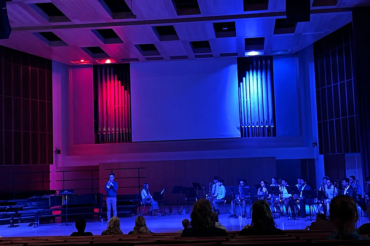 Student playing a trumpet on stage