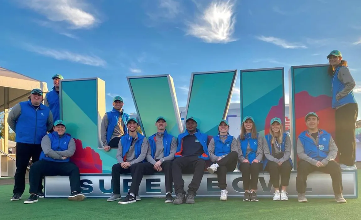 Students in front of the SB logo