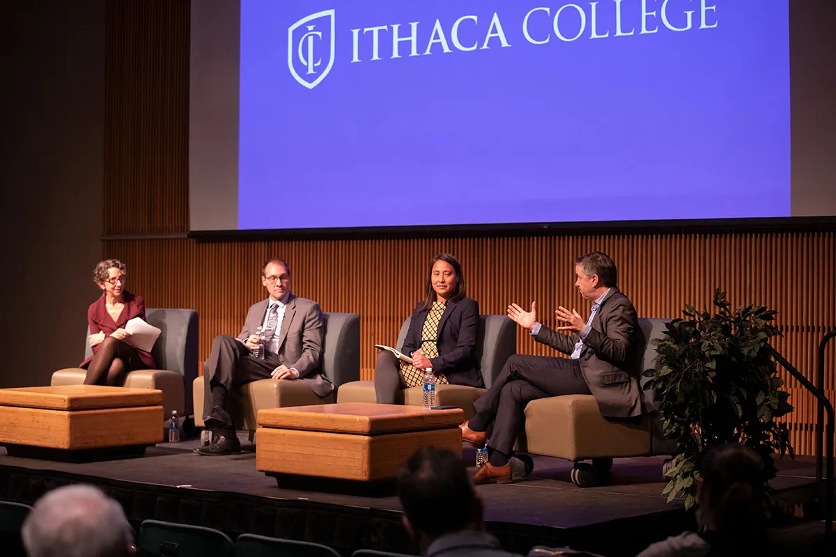 The four panelists on a stage