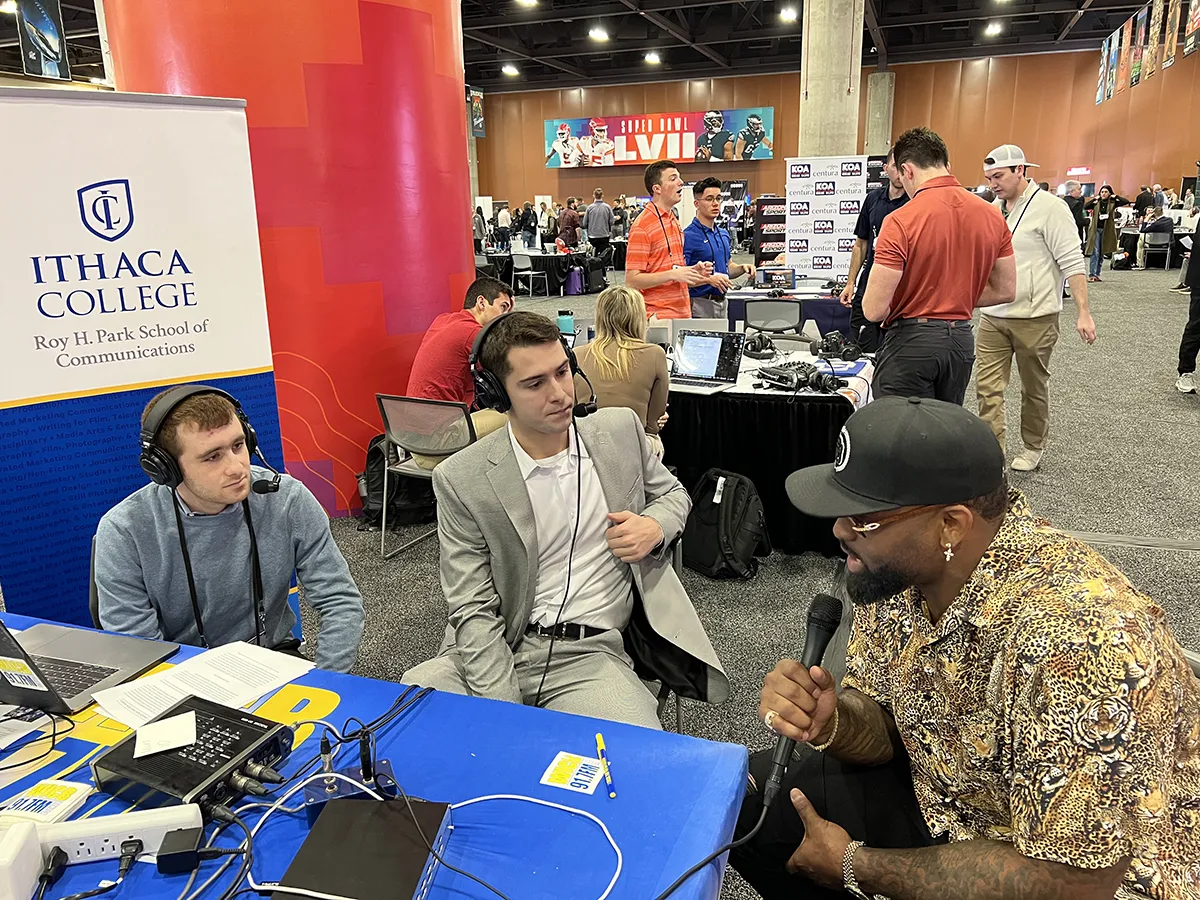 Students interviewing a player