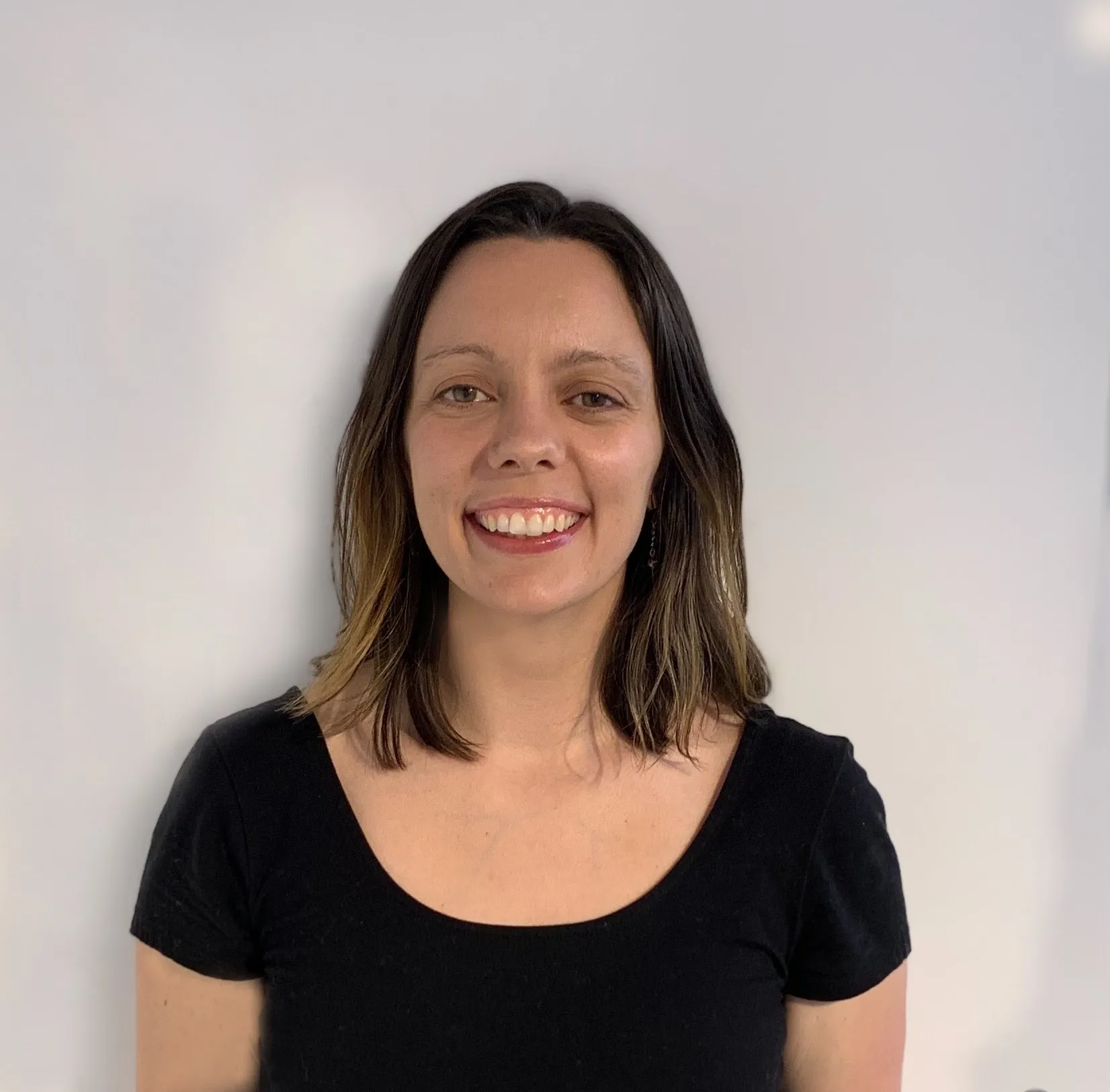 Headshot of Sara Gosses, a woman with brunette hair in a black shirt