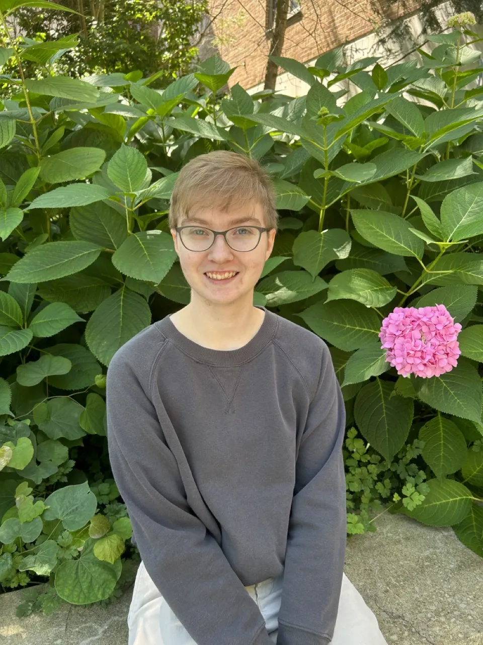 person sitting in front of a tree and smiling
