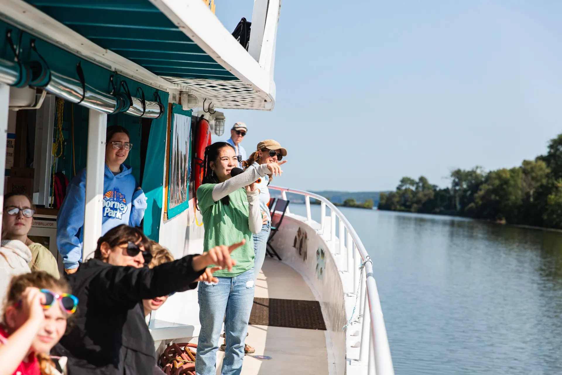 People on a boat, looking toward the shore