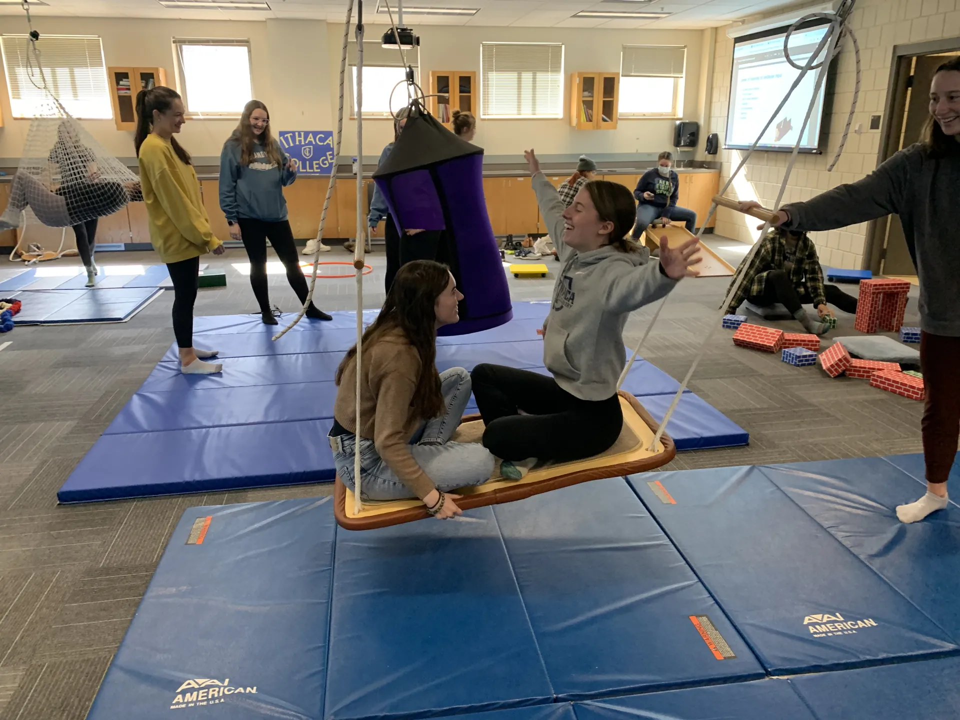 Students using different types of swings in lab in a classroom