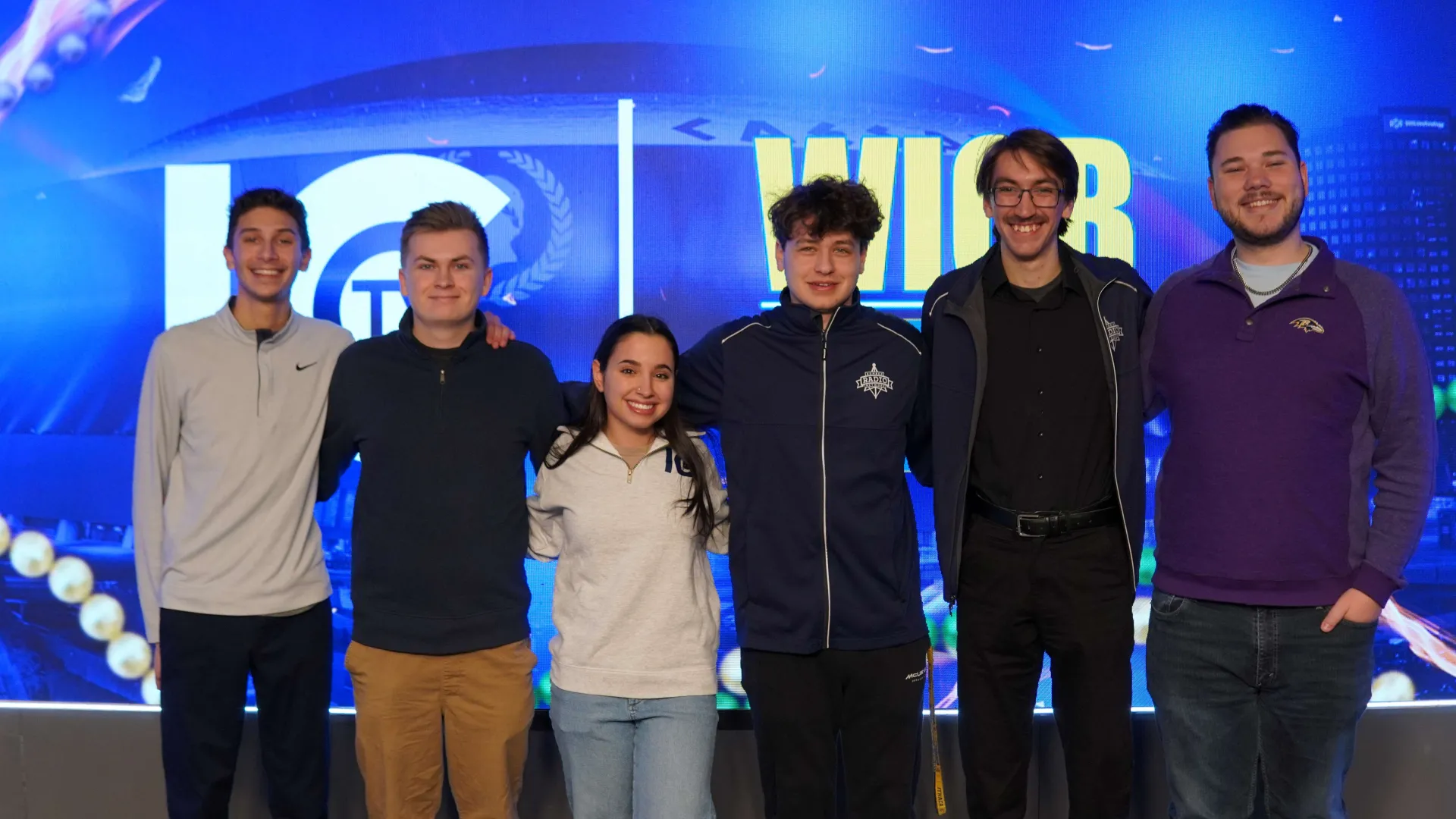 Six students stand in a group photo.