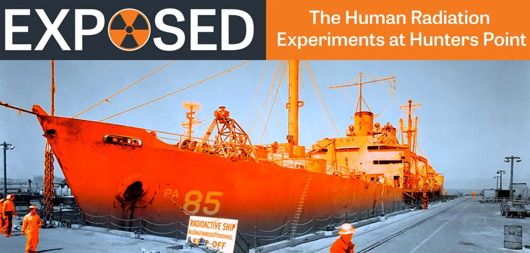 Orange ship at a dock.