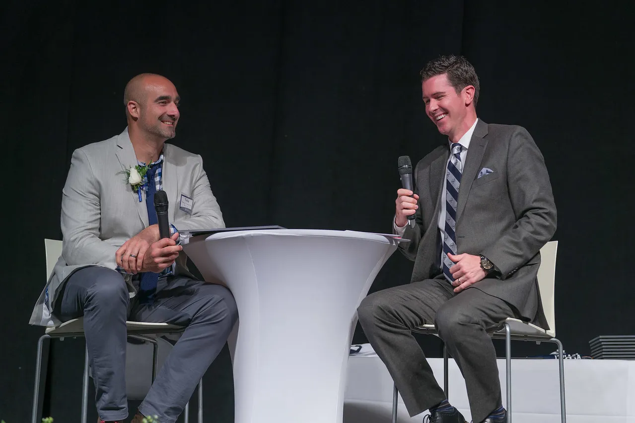 Tariq with Kevin Conners at a table