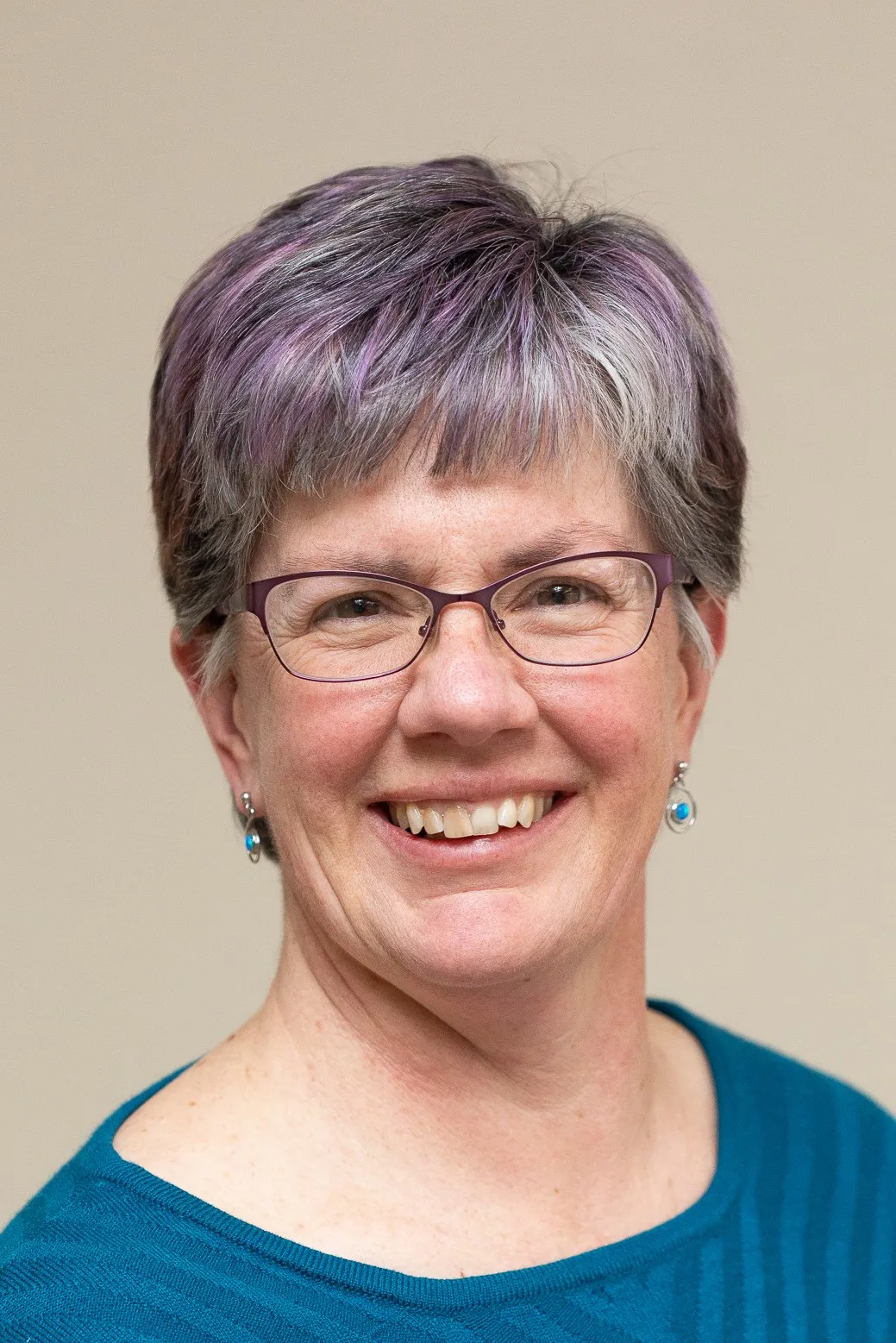 Photo of a woman with short dark hair and glasses.