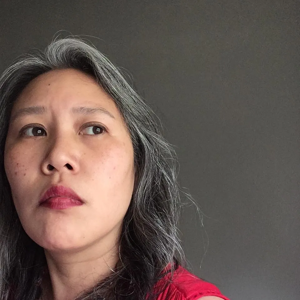 an asian woman in a red blouse