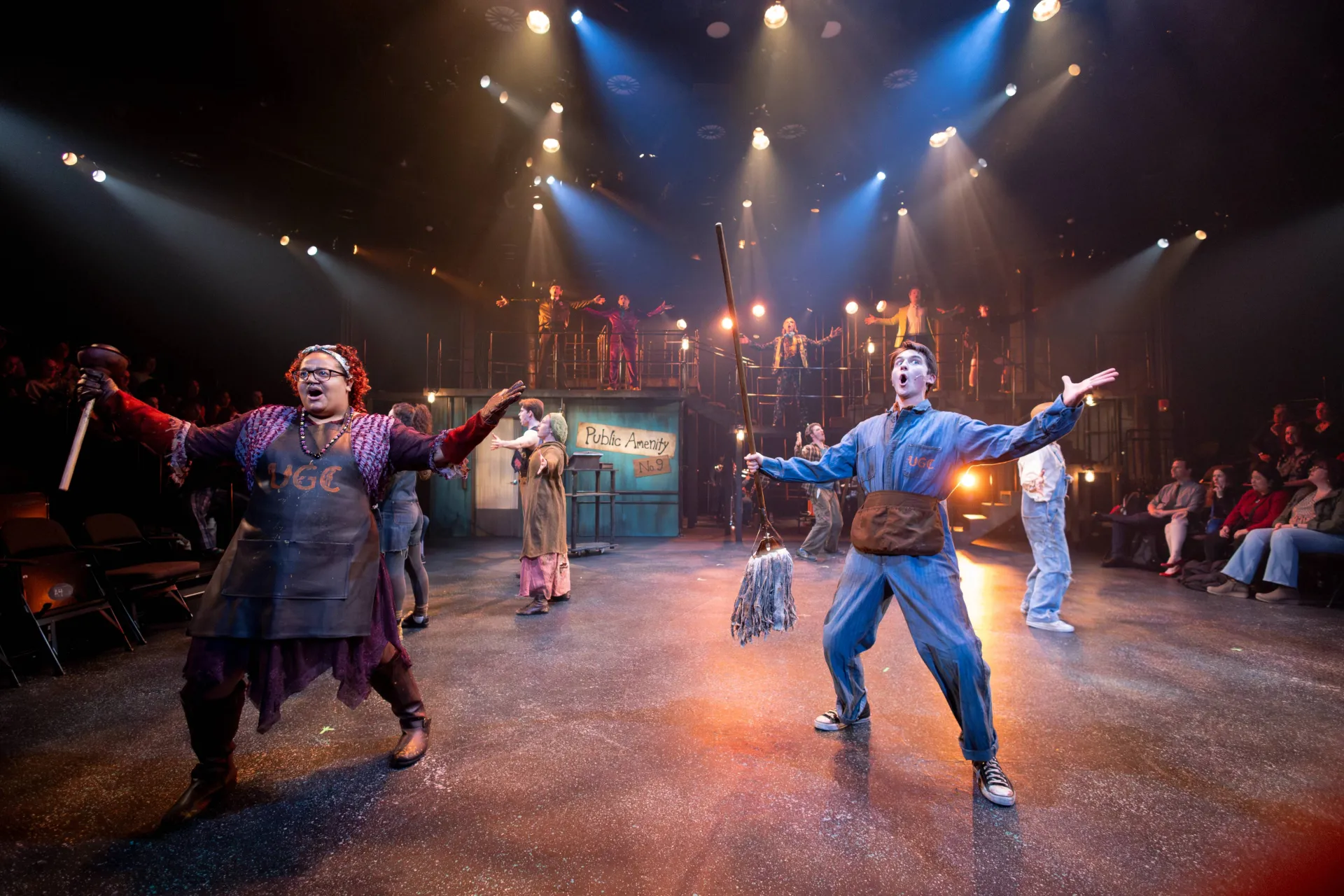 People singing and dancing on a stage.