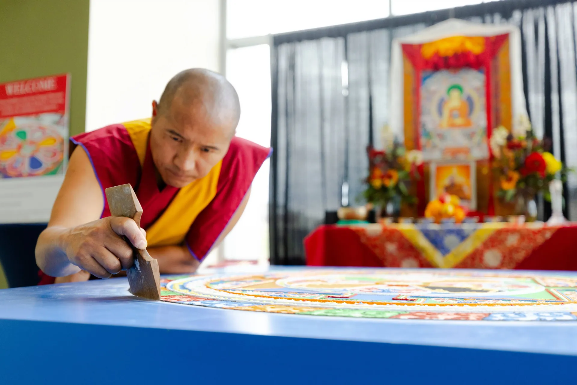 Buddhist monk making a sand mandala.