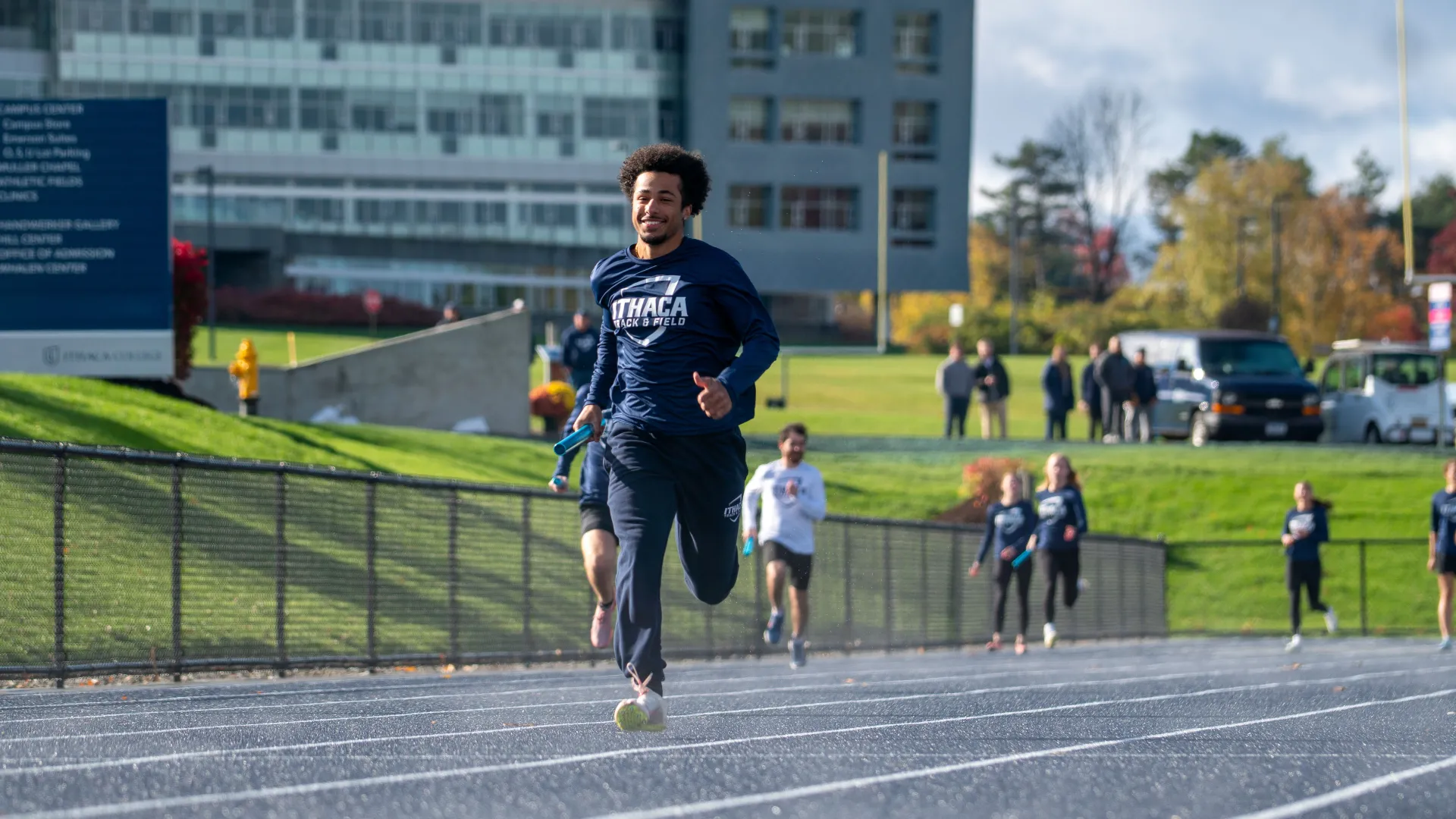 A college student runs on a track.