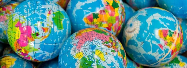 A number of small, colorful globes in a pile