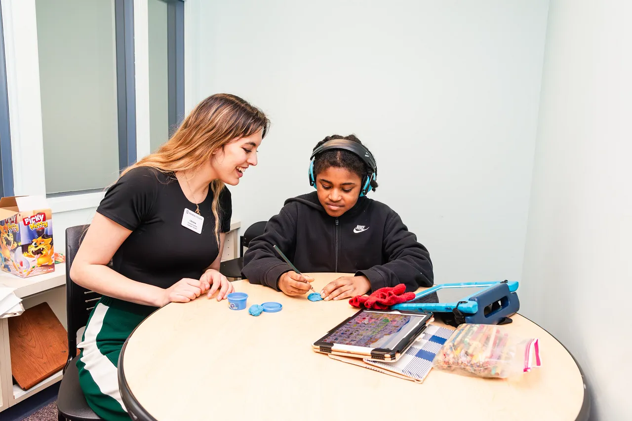 SLP student providing therapy with AAC.