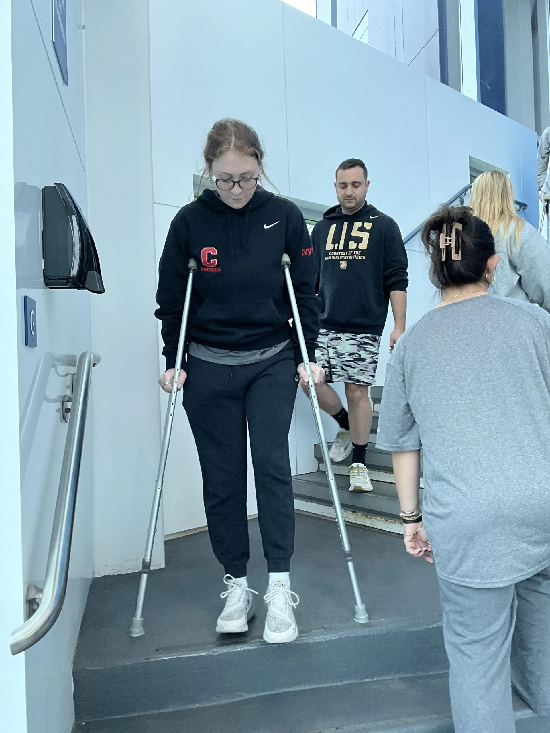 Students practicing safely using crutches to use stairs