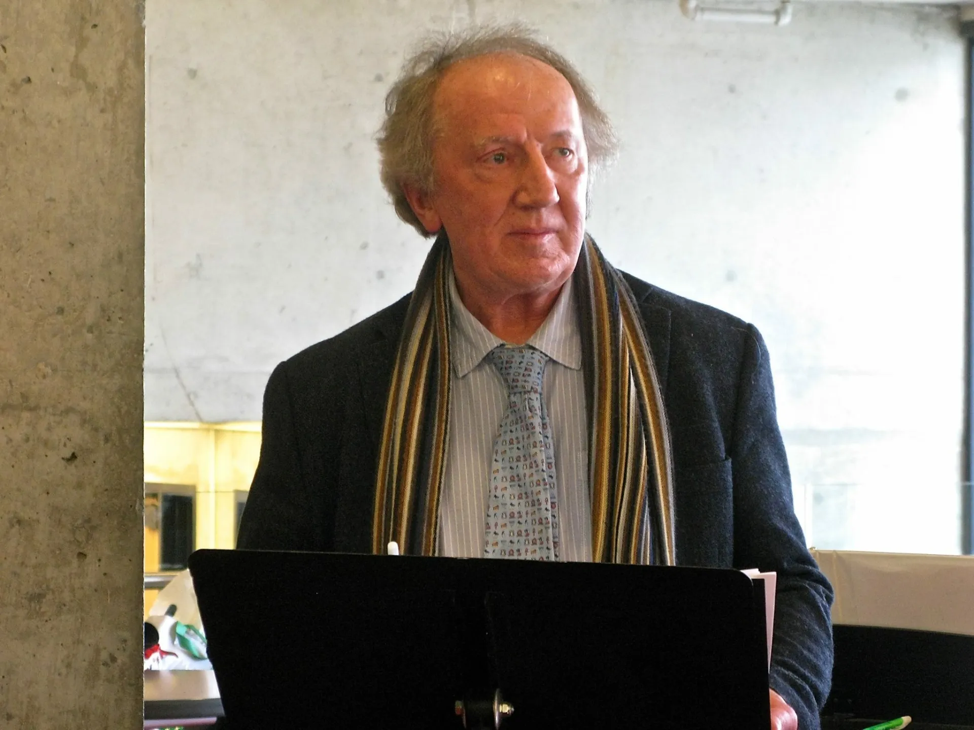 Bill Sheasgreen, former director of the Ithaca College London Center, standing at a podium giving a speech