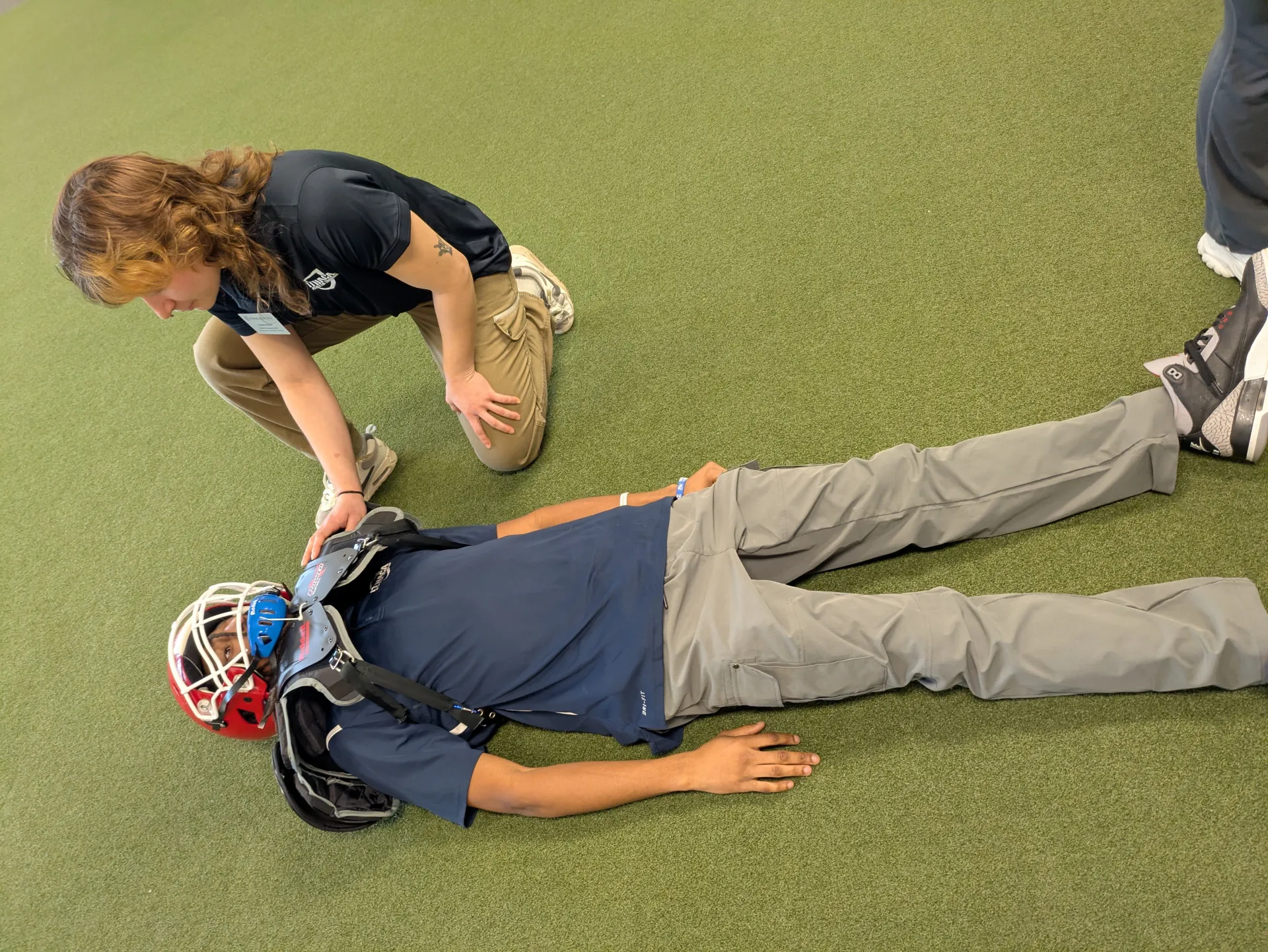 assessing athlete on the ground