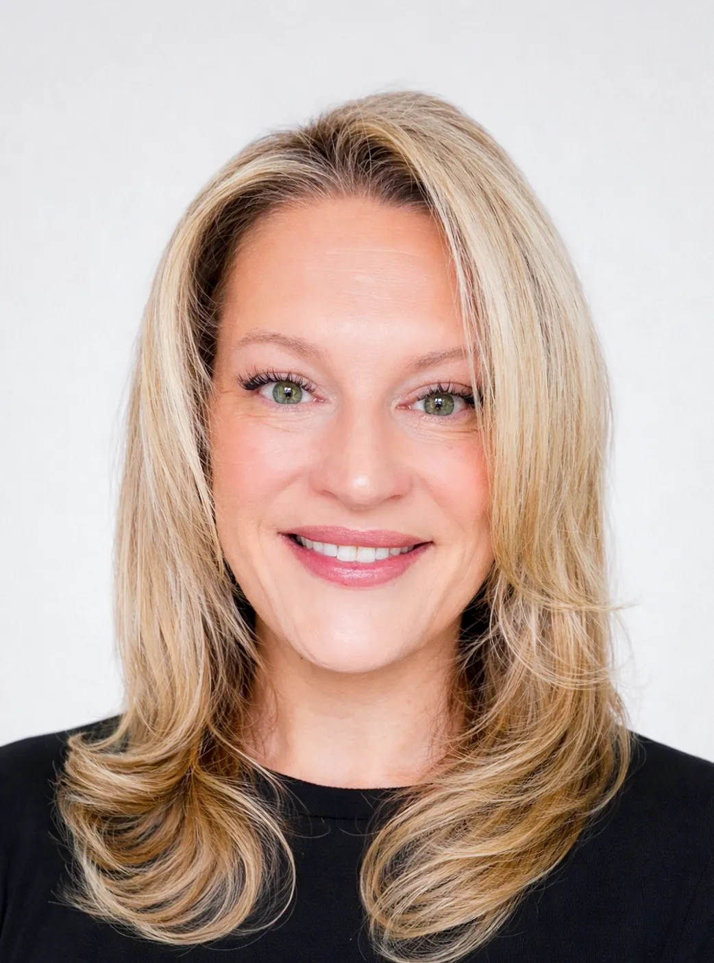 Amy Rominger headshot. Shows white woman with blonde hair smiling. 