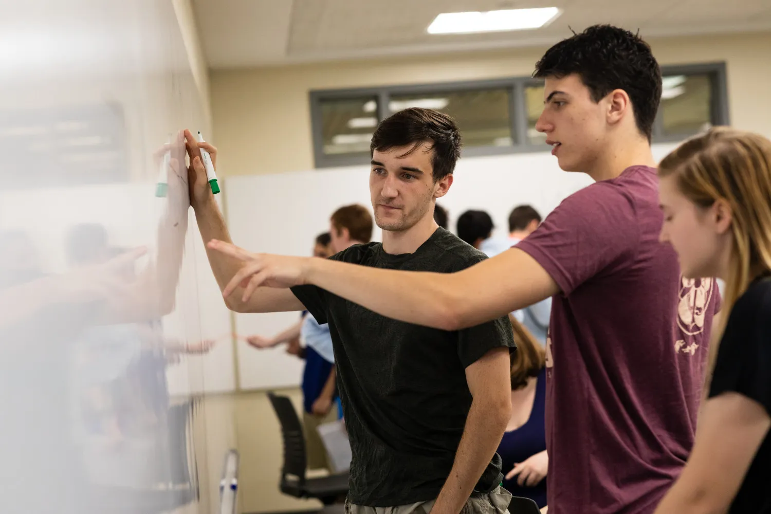 Students share ideas on a whiteboard.