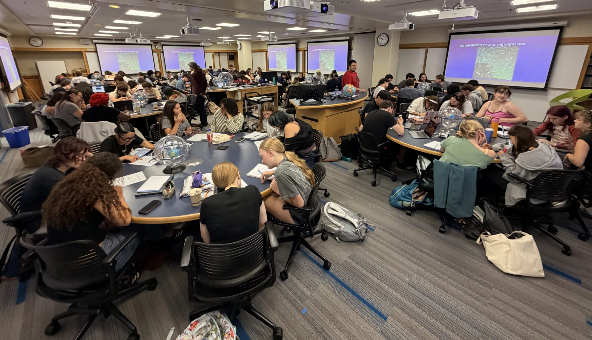 Students in Professor Beth Ellen Clark Joseph's Stars, Galaxies, and the Universe class work together in groups to explore the celestial sphere.